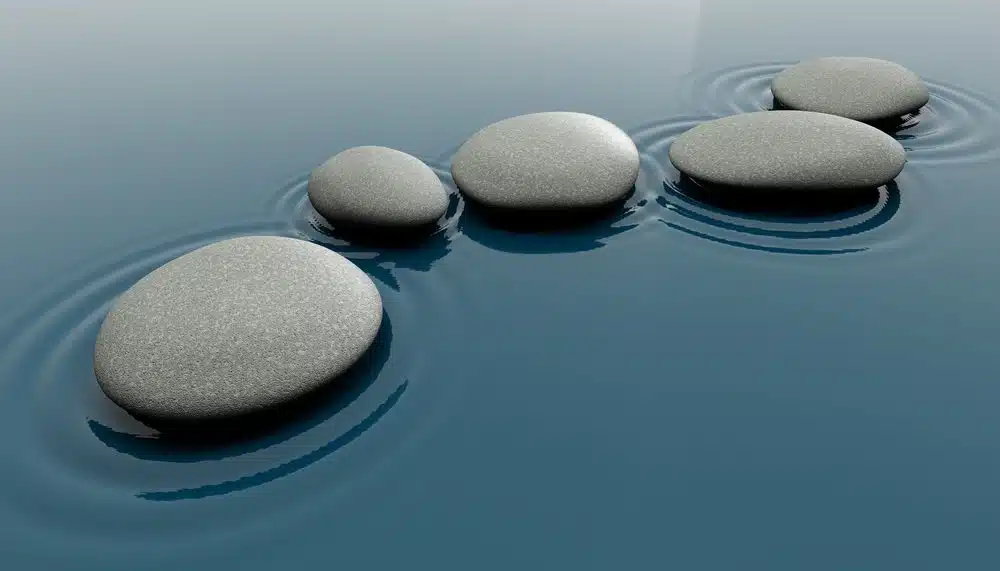 Smooth stones on calm water creating a serene landscape