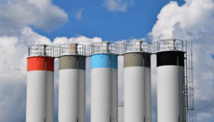 Colourful industrial silos against cloudy sky