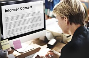 Woman reviewing informed consent document on computer in office