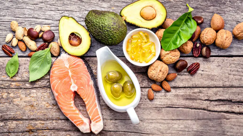 Selection of healthy fats: salmon, nuts, avocado, olive oil