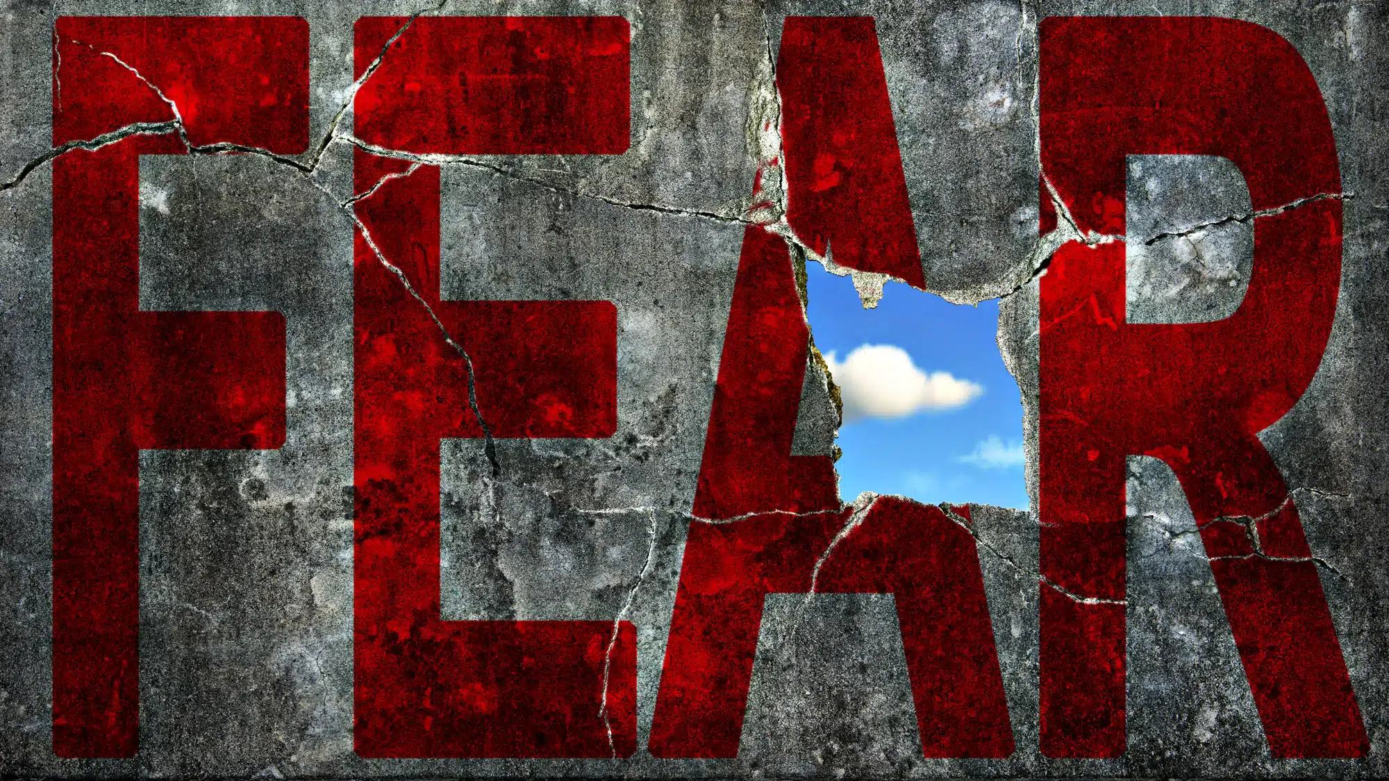 Cracked wall with red 'FEAR' revealing blue sky