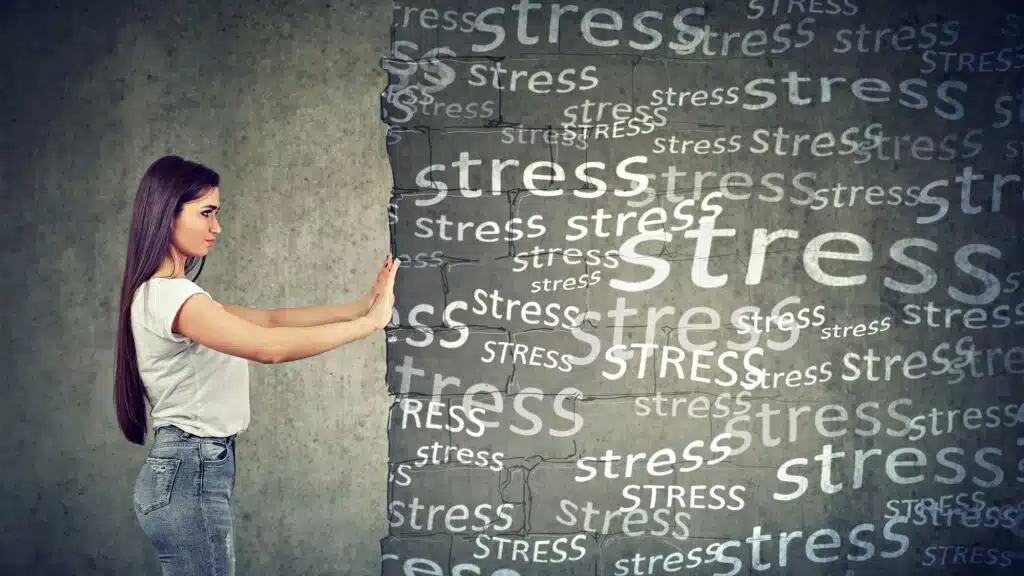 Woman pushing back stress concept wall symbolizing personal struggle