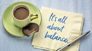 Coffee with chocolate biscuit, napkin, pen, balance message