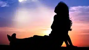 Silhouette of person against vibrant sunset sky
