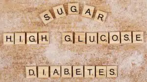 Scrabble tiles spelling sugar, high glucose, diabetes on sugared surface