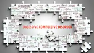 Obsessive Compulsive Disorder text surrounded by mental health keywords on puzzle pieces