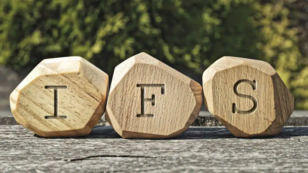 Wooden blocks with letters IFS on a rustic table
