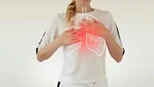 Woman illustrating chest pain with glowing lung overlay