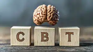 Concept of CBT with brain model on wooden blocks