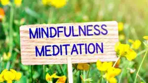 Mindfulness meditation sign in a field of yellow flowers