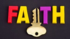 Faith word in colourful letters with key symbol on black background