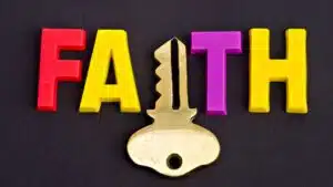 Faith word in colourful letters with key symbol on black background