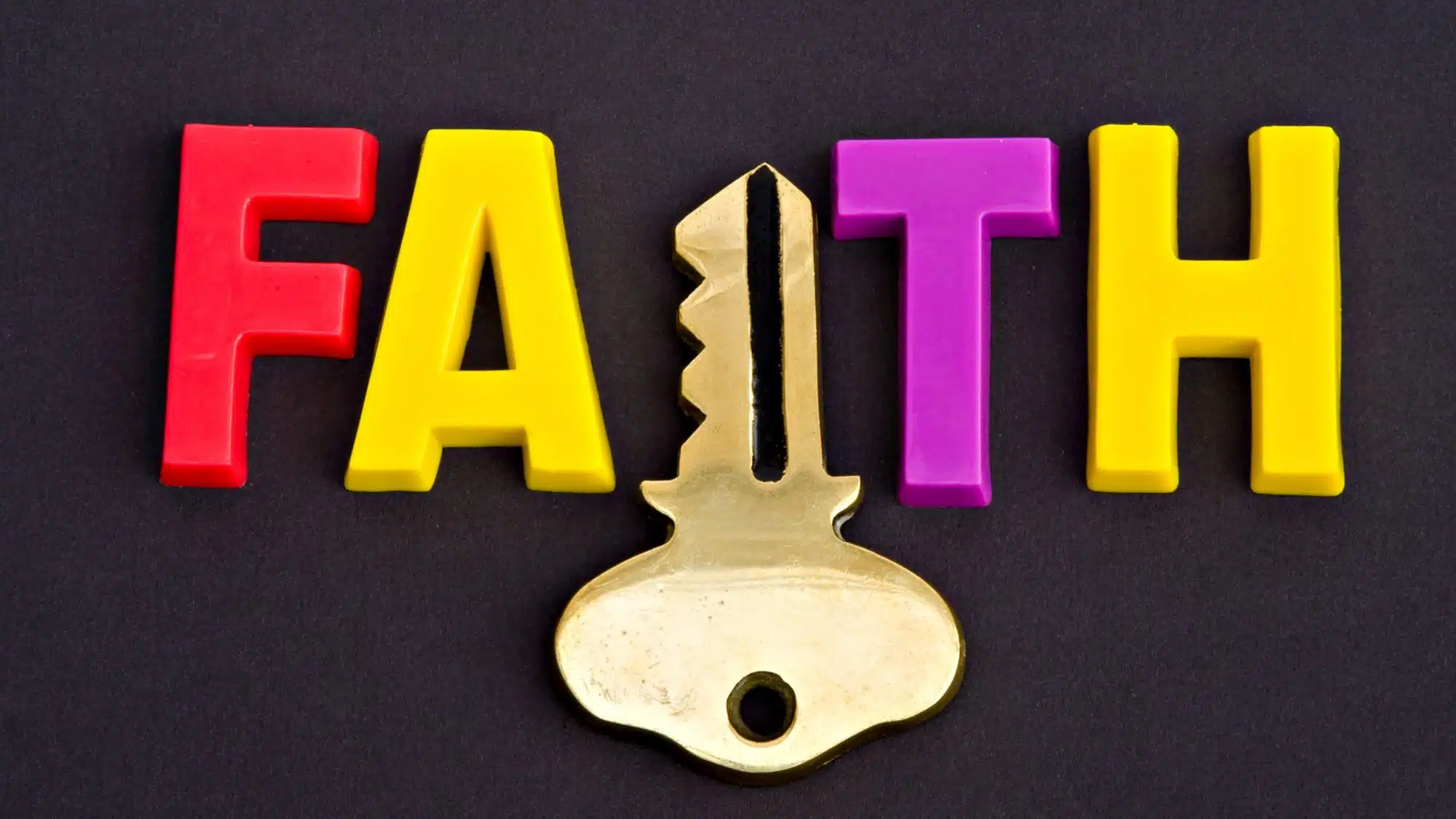 Faith word in colourful letters with key symbol on black background