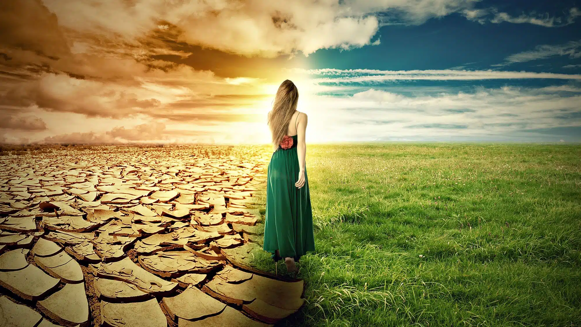 Woman walking from barren land to lush field under dynamic sky
