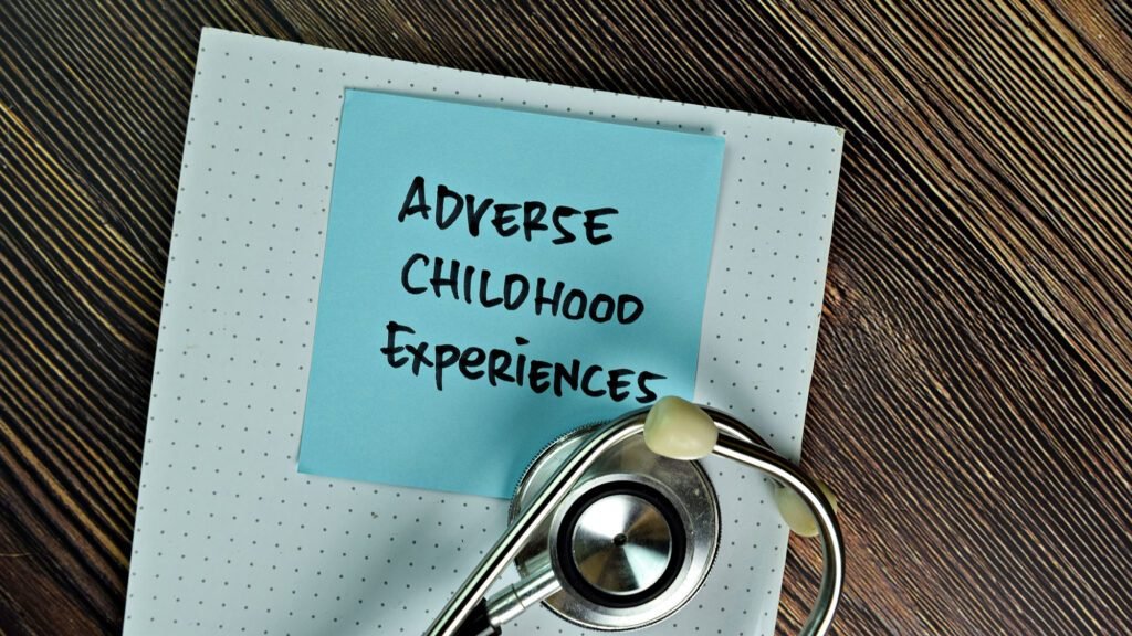 Adverse Childhood Experiences note with stethoscope on wooden desk