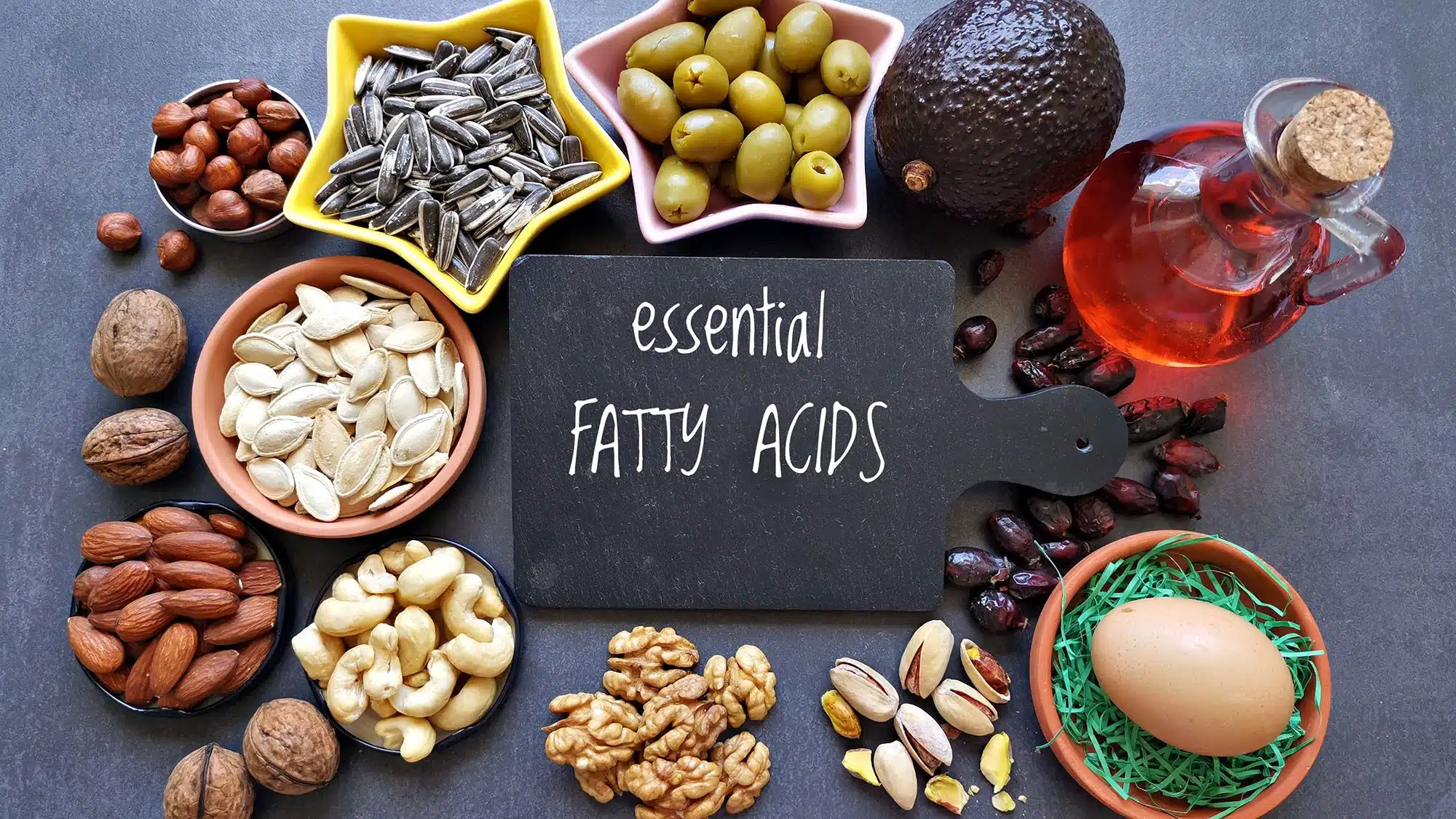 Healthy foods rich in essential fatty acids displayed on a dark surface