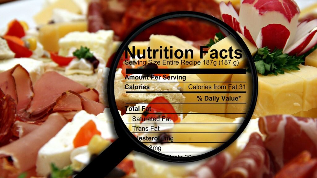 Magnified nutrition facts over assorted cheese and meats platter