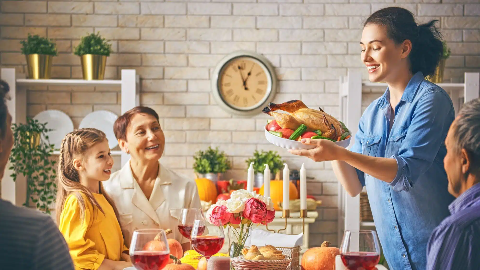 Family enjoying Thanksgiving dinner with turkey and wine