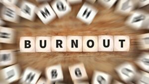 Burnout concept depicted with wooden letter blocks in focus