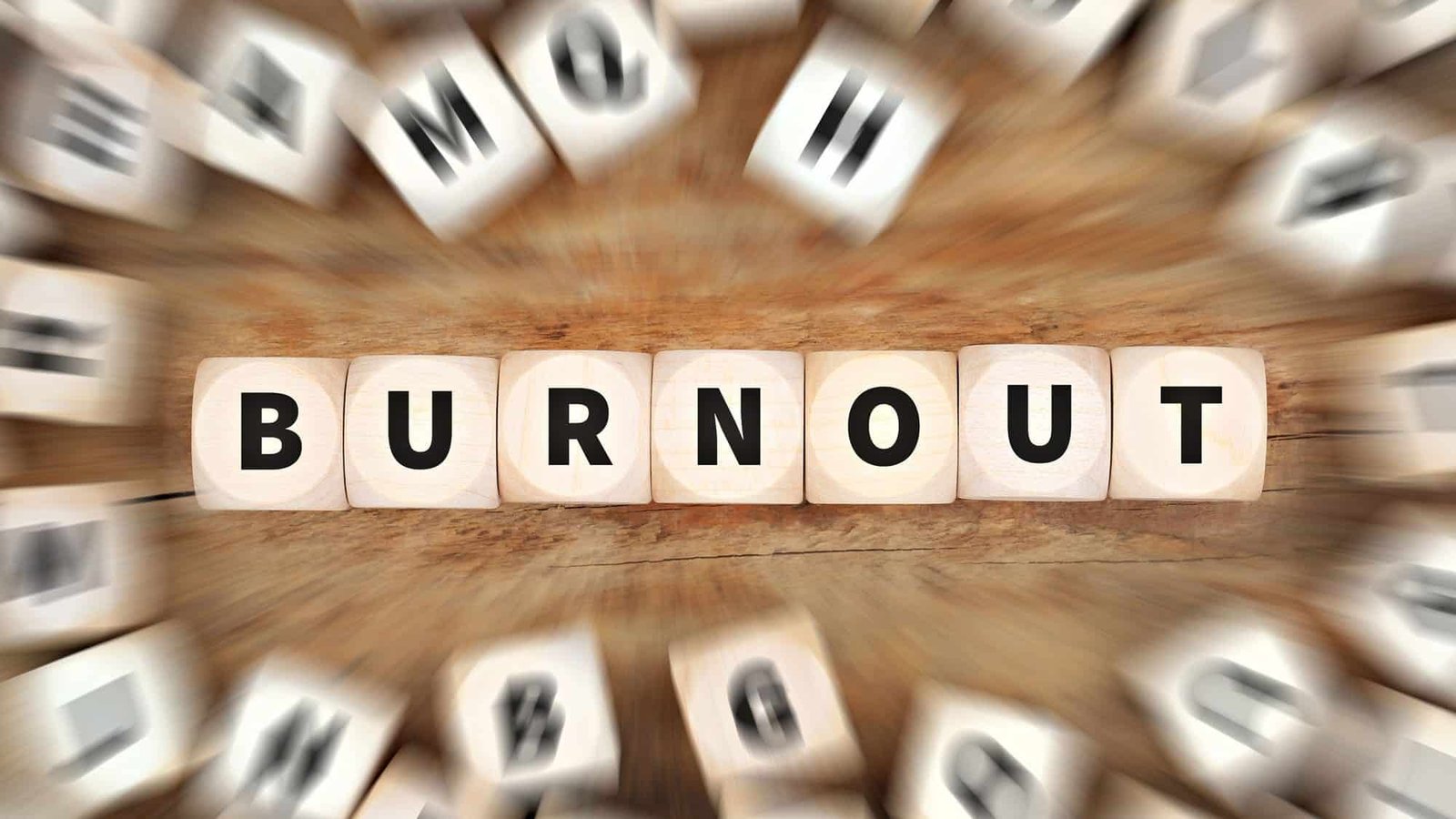 Burnout concept depicted with wooden letter blocks in focus
