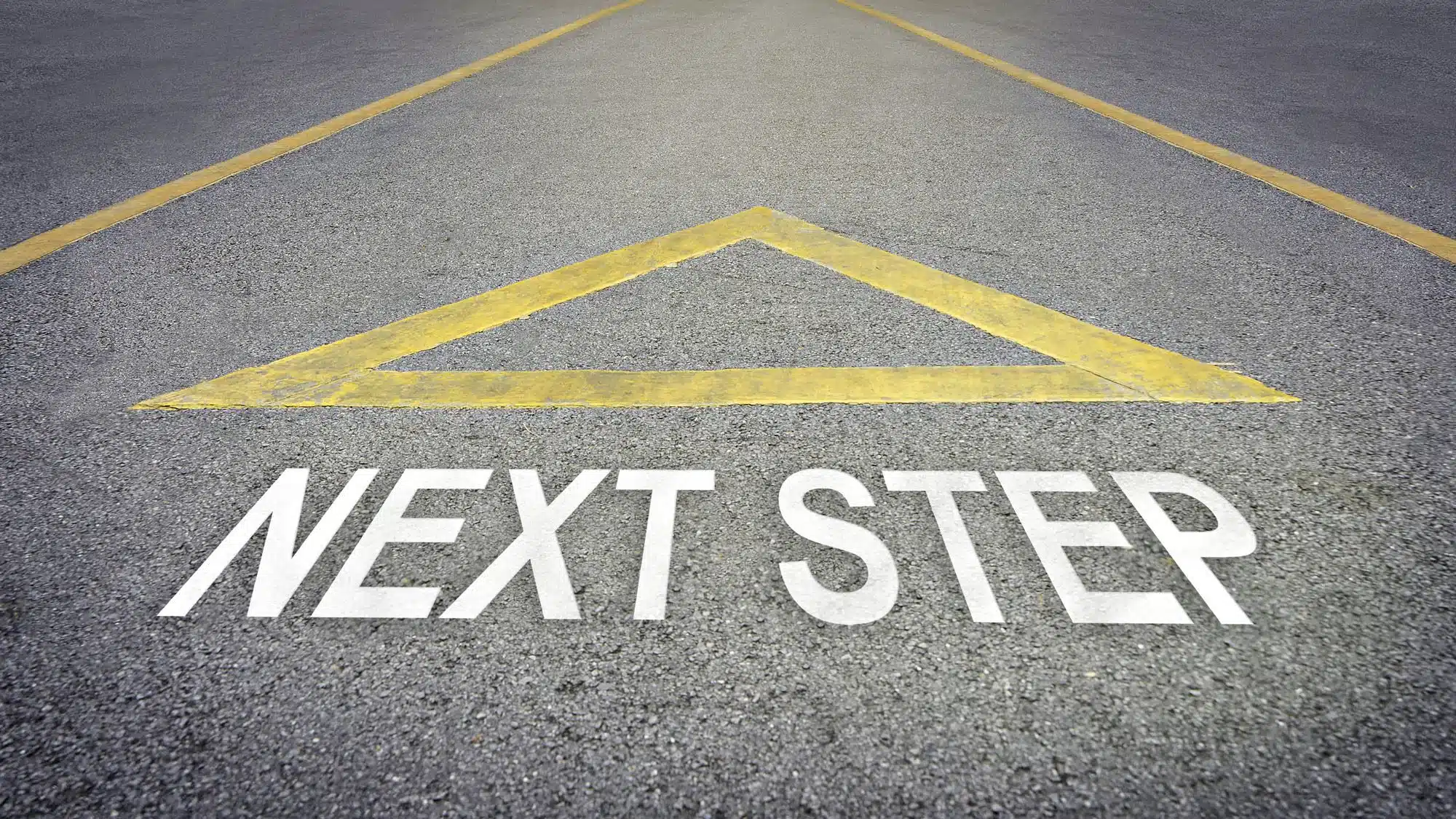 Road with 'NEXT STEP' and triangle, symbolizing progression