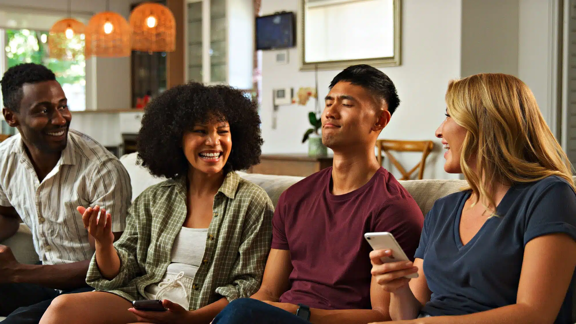 Friends enjoying a lively conversation on a sofa in a modern living room