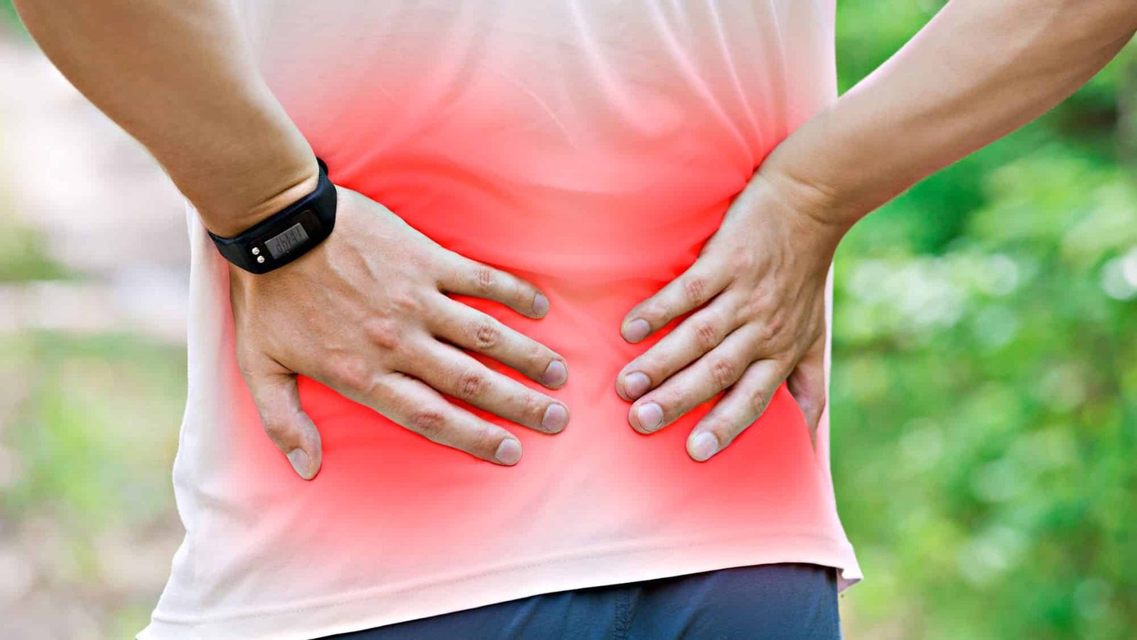 Person with lower back pain in red highlighted area outdoors