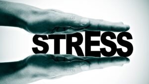 Hands pressing the word 'stress' representing stress management
