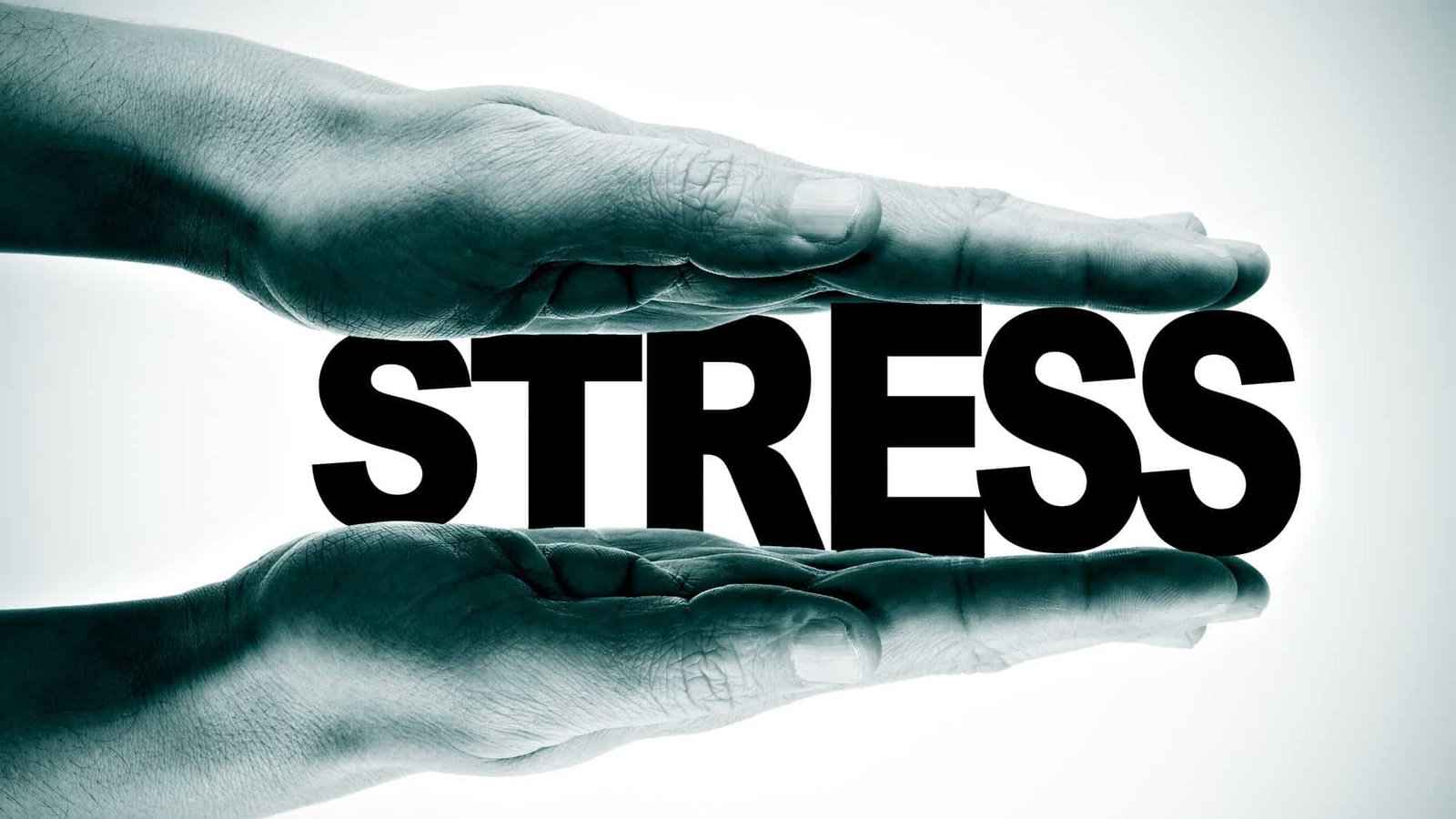 Hands pressing the word 'stress' representing stress management
