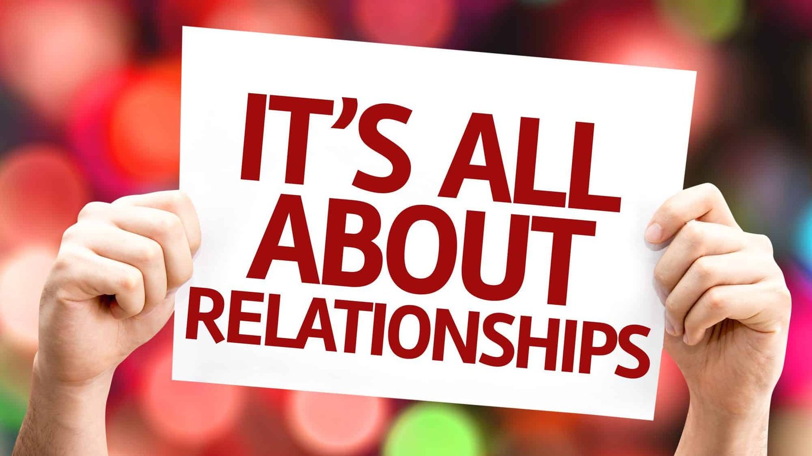 Sign reading 'It's All About Relationships' against colourful background