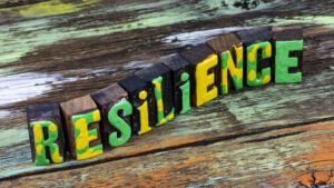 Colourful wooden blocks spelling 'Resilience' on a rustic table