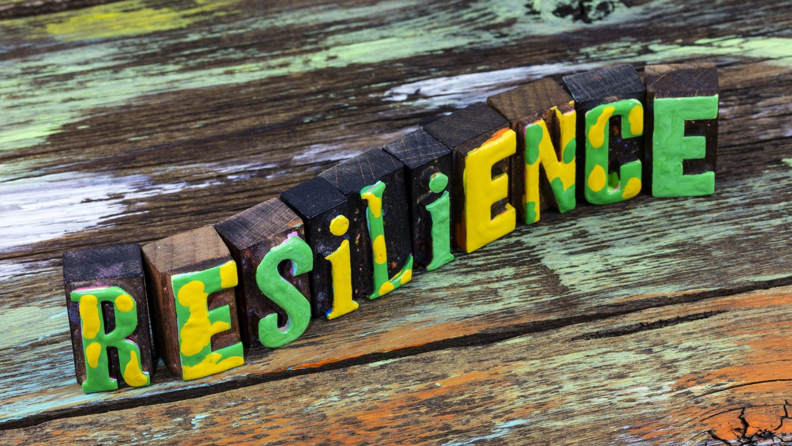Colourful wooden blocks spelling 'Resilience' on a rustic table